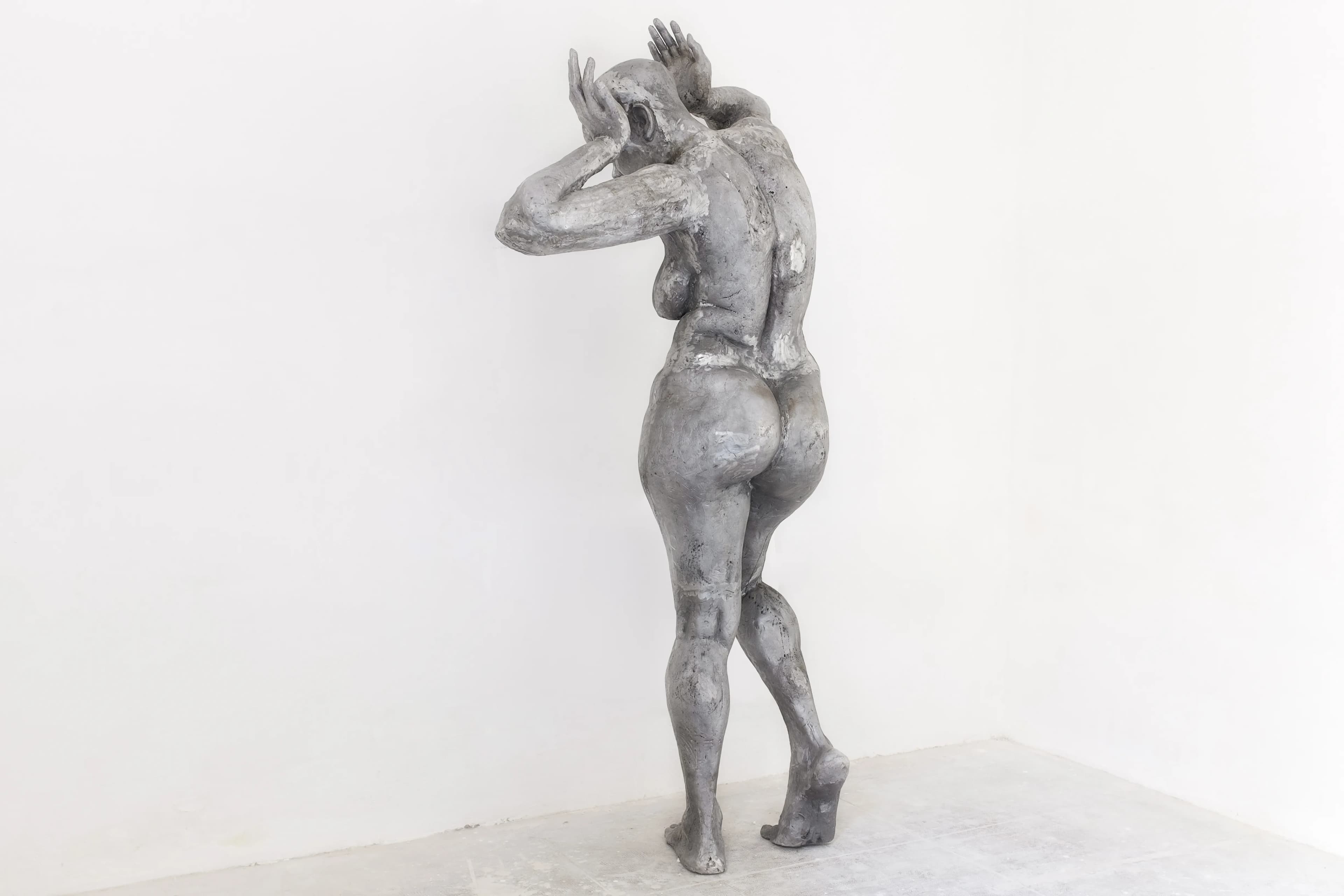 Pandora: a 230 cm tall cast aluminium sculpture of a beautiful African woman, contrapposto with hands framing her head